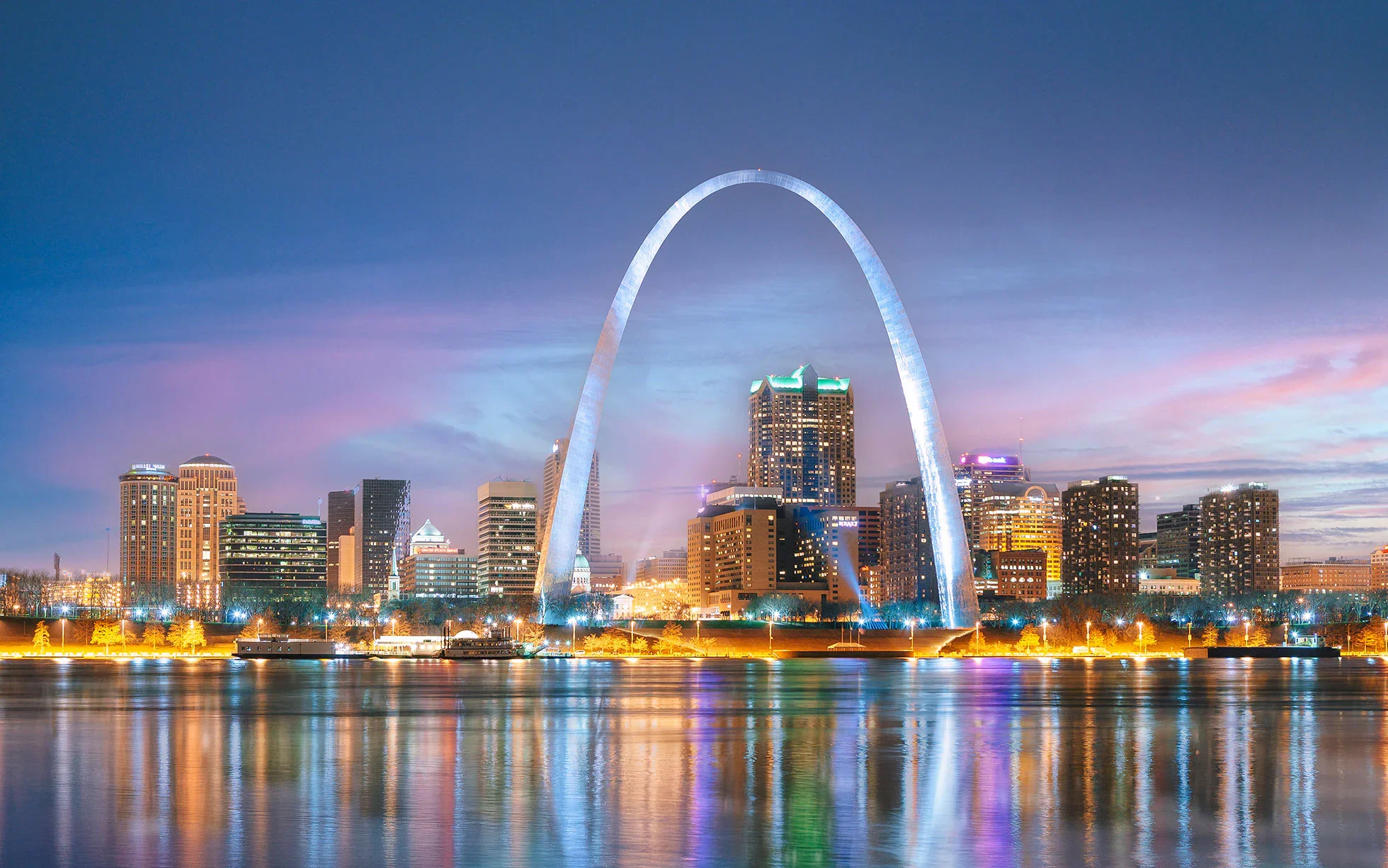 St. Louis skyline and Gateway Arch at sunset, reflected in the Mississippi River