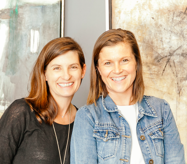 Two women smiling at a Beyond Coffee art event