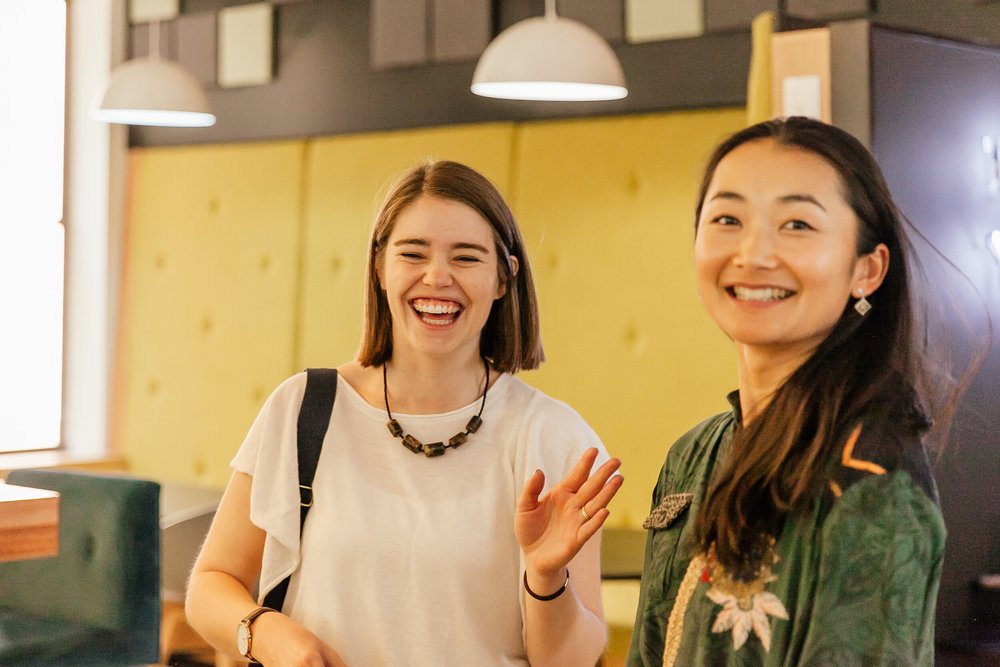 Two women laughing at a Beyond Coffee event