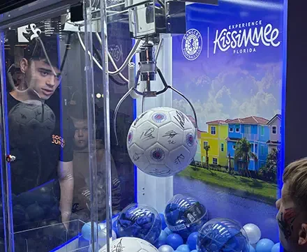 The Claw branded prize machine hire — oversized claw machine fan activation at a sporting event by Social Jungle