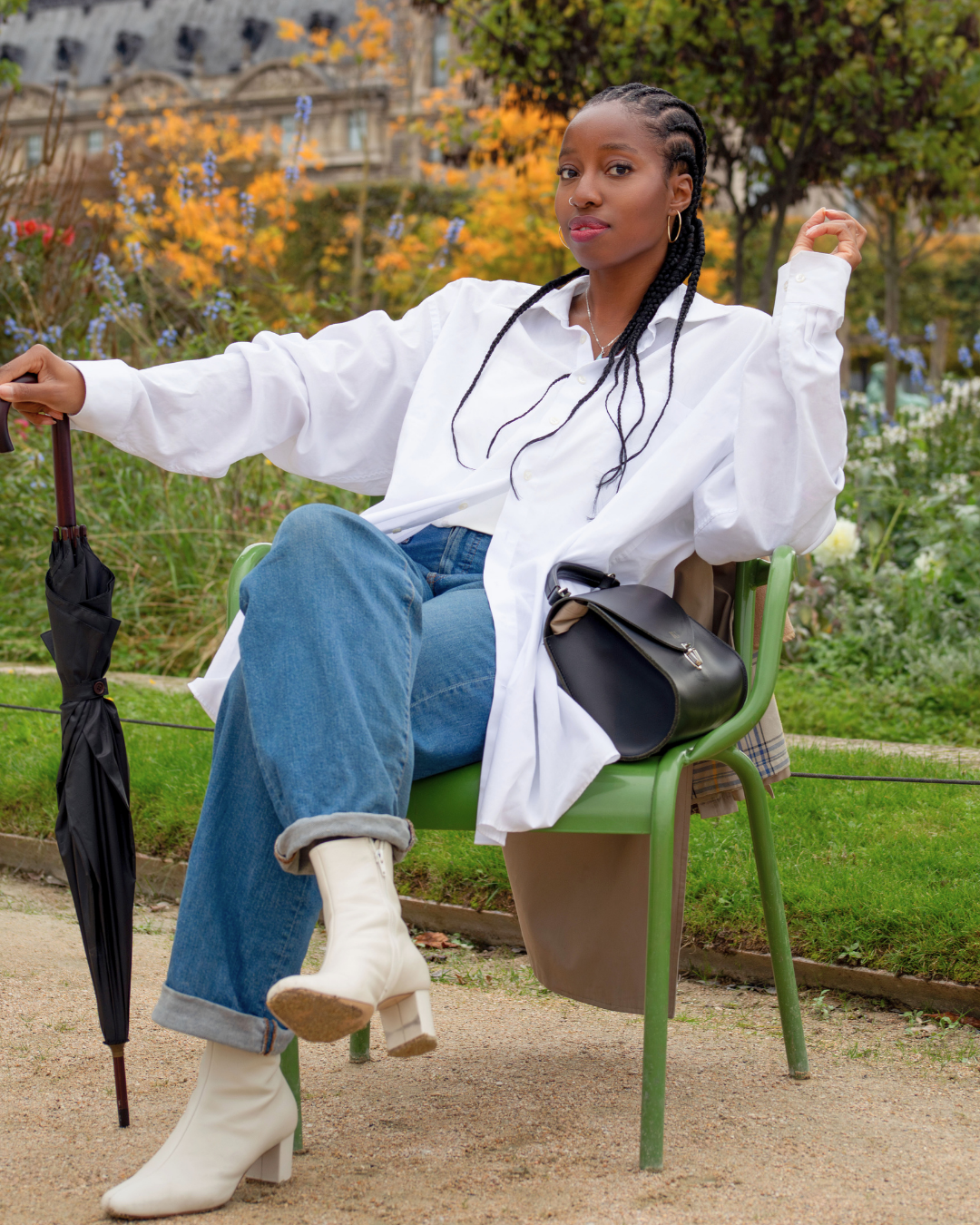 Biola in Paris, seated in a park with an umbrella