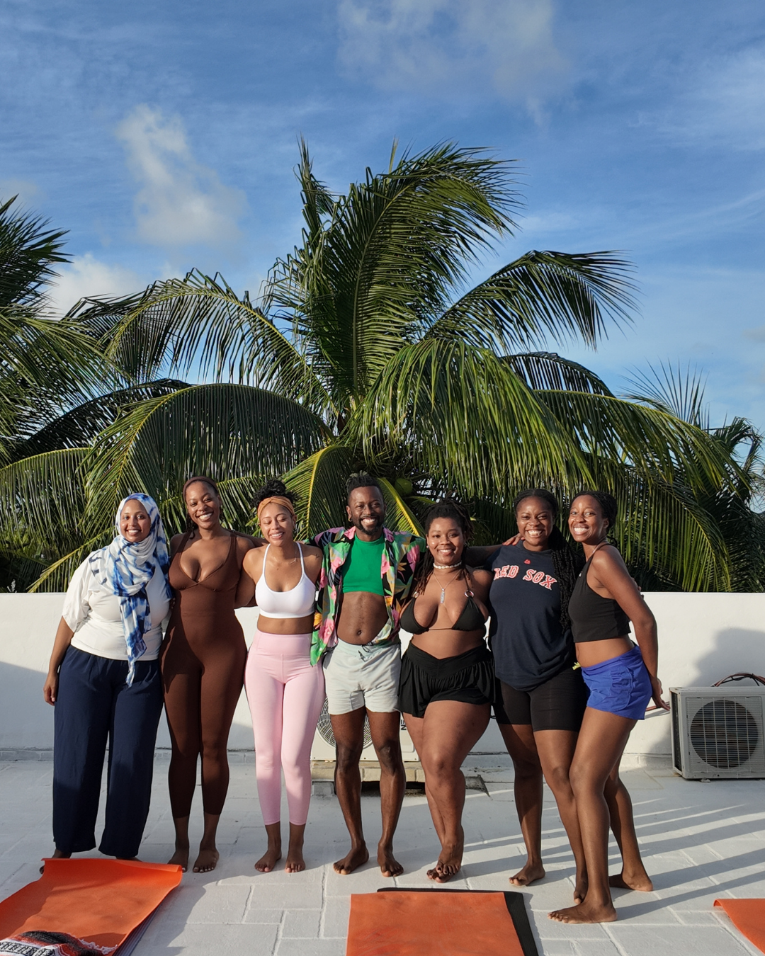 Biola and a group of retreat participants on a rooftop with palm trees