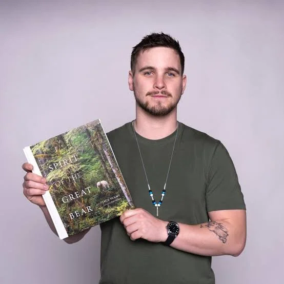Jack Plant holding his photography book Spirit of the Great Bear