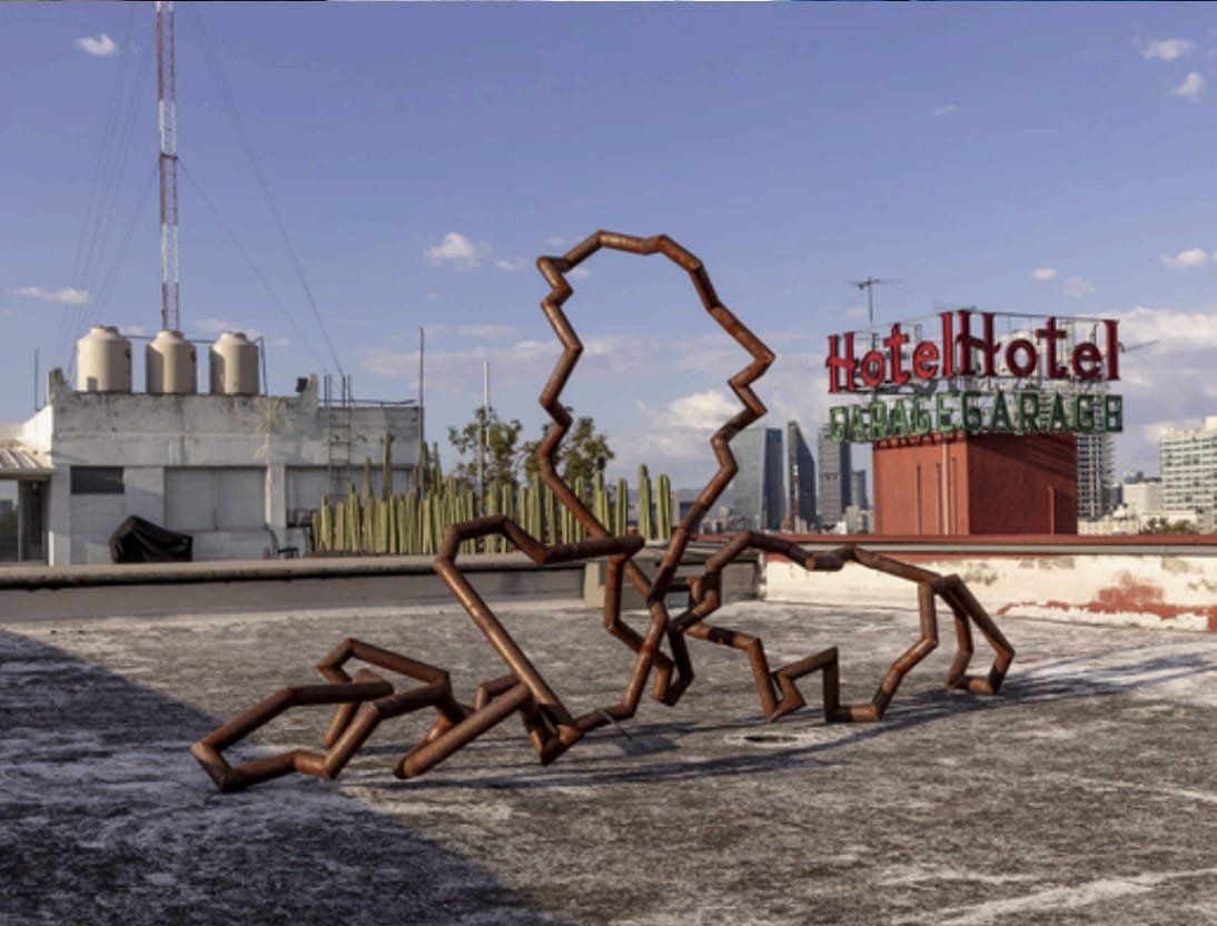 Rusted steel sculpture on a rooftop overlooking México City