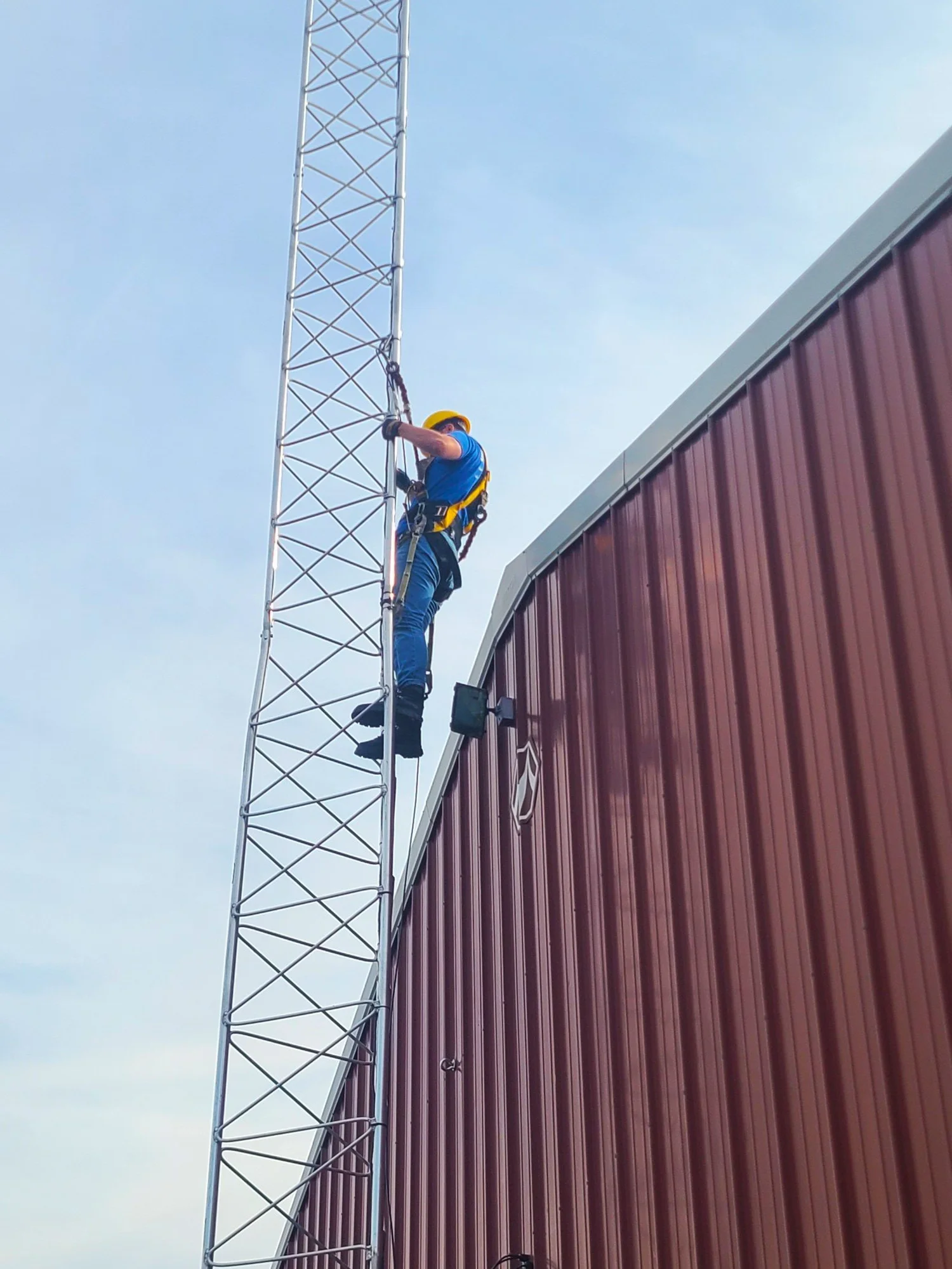 DerbyNet tech climbing one of our towers