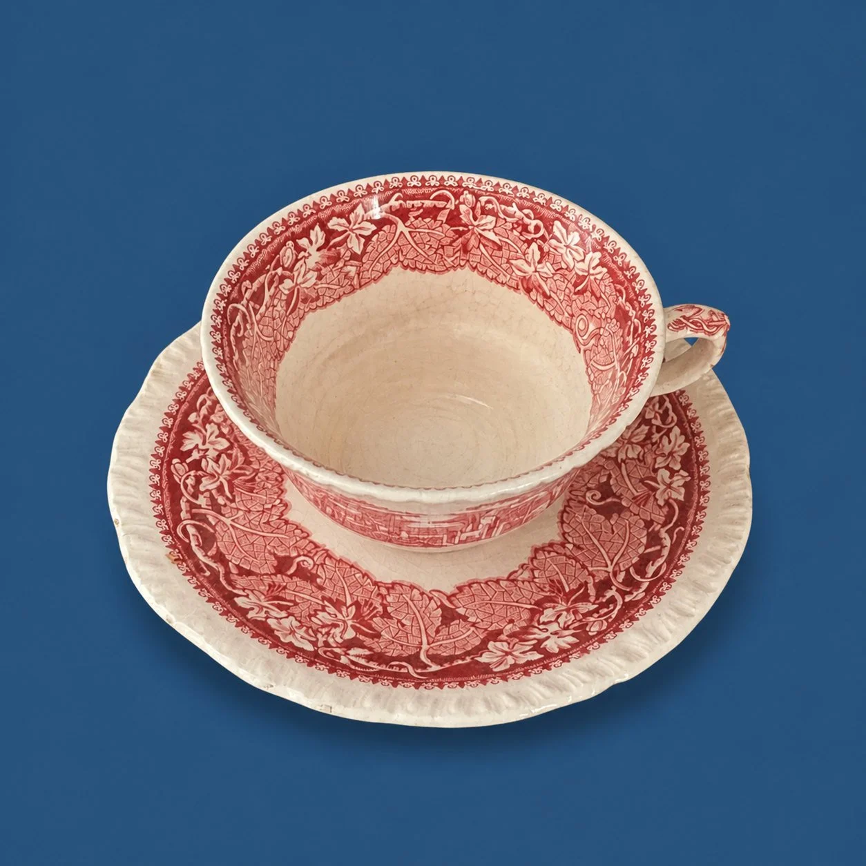 Red Transferware Teacup and Saucer by Maker unrecorded