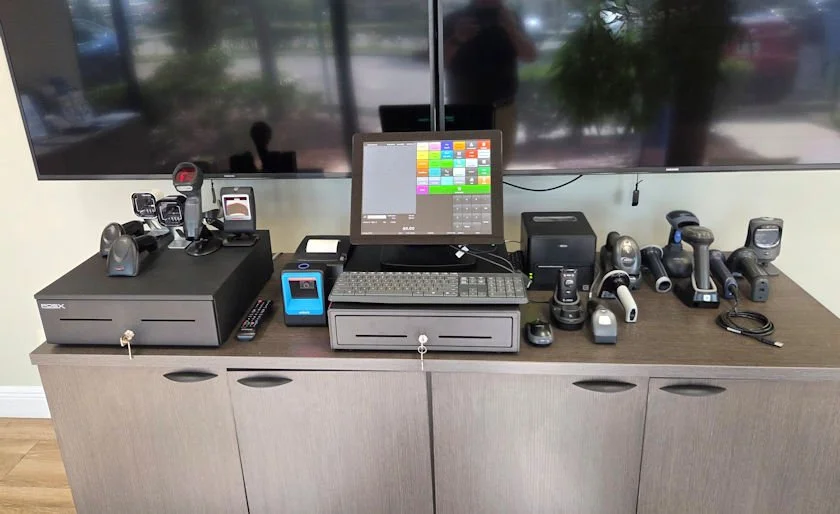 BizTracker showroom display with POS terminals, barcode scanners, receipt printers, cash drawers, and payment hardware