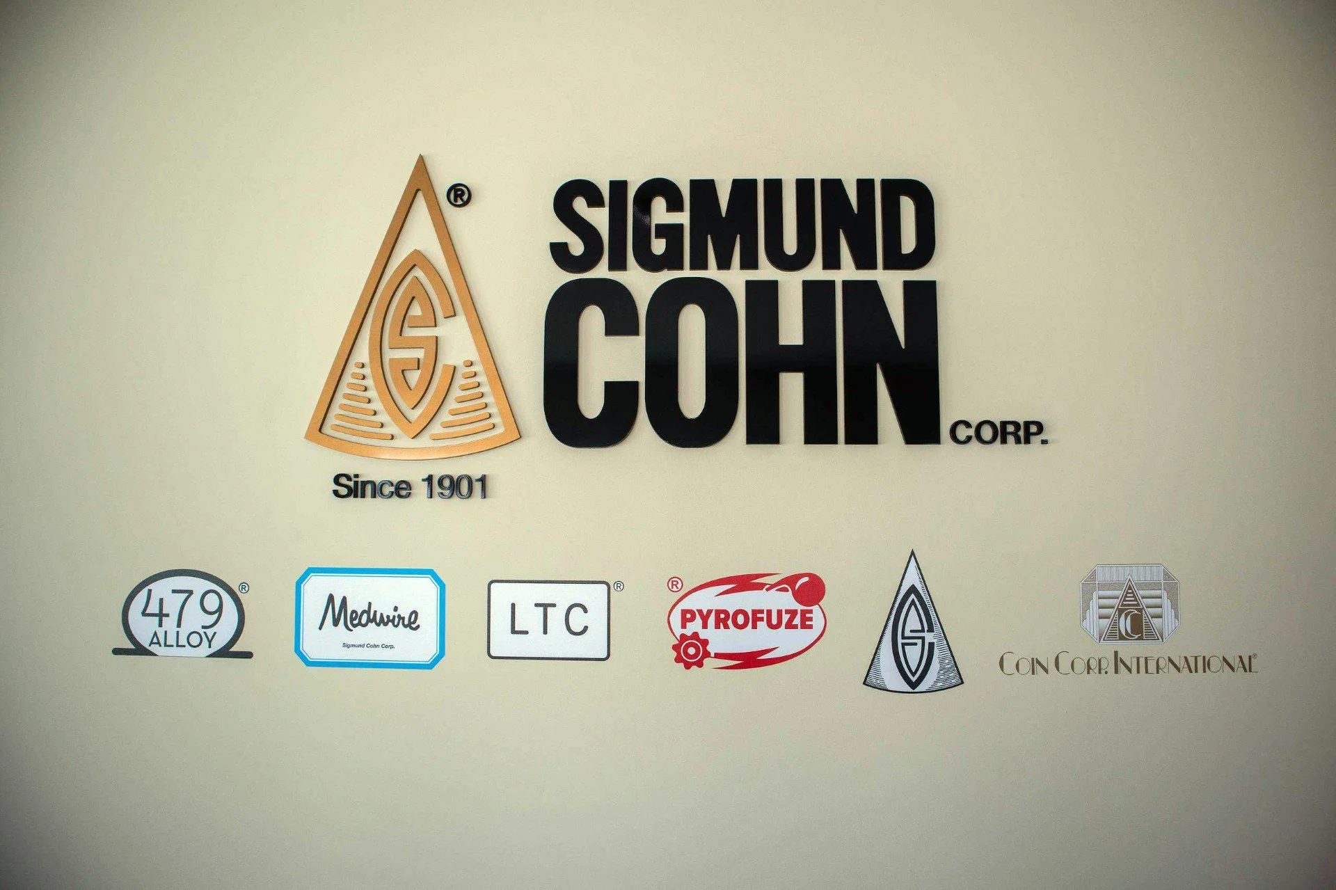 Sigmund Cohn Corp. lobby wall showing the company mark and the 479 Alloy, Medwire, LTC, Pyrofuze and Coin Corp. International brand marks