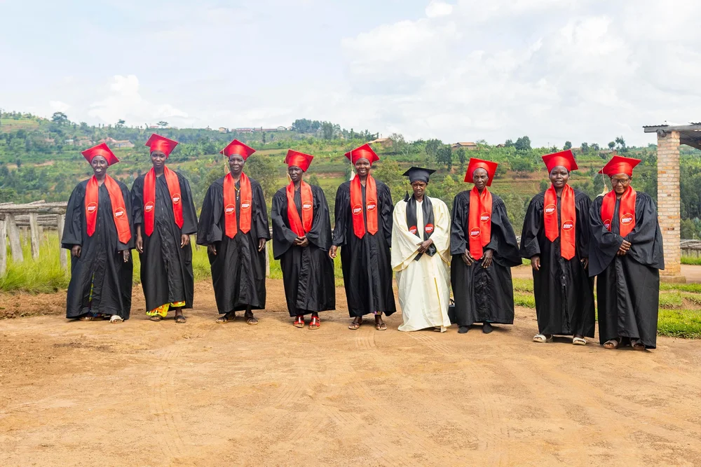 Placeholder photo — group of graduates in red robes (unconfirmed match, please verify)