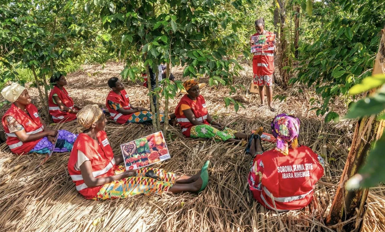 Placeholder photo — women farmers gathered under trees during a training session