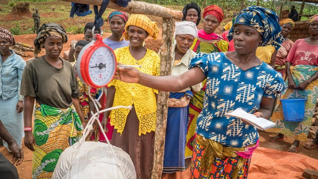 Placeholder photo — women farmers with a livestock scale