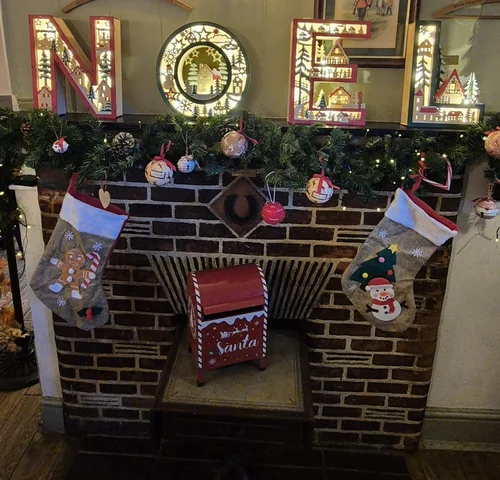 The fireplace hung with Christmas stockings