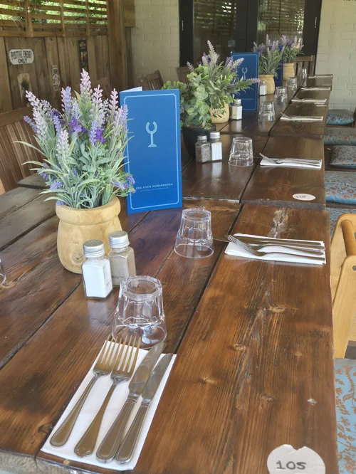 A long table laid with lavender in the dining room