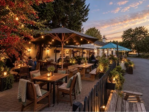 Evening on the front terrace, with lanterns, parasols and blankets on the chairs