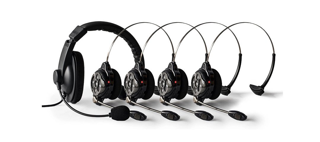 Wired headset and four C-Com Pro wireless headsets