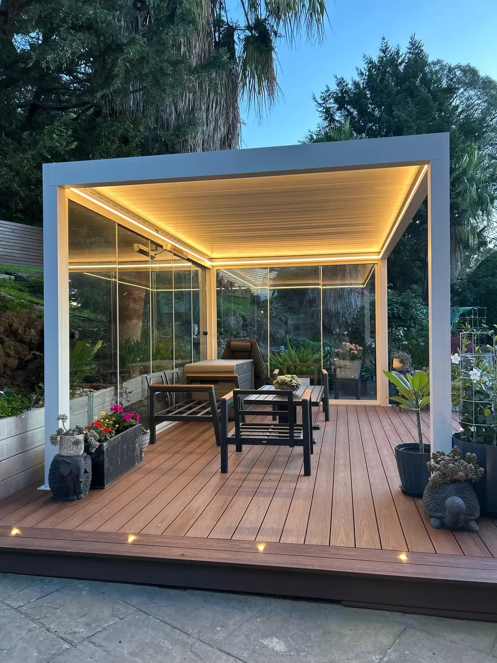 Louver pergola with glass walls and LED lighting