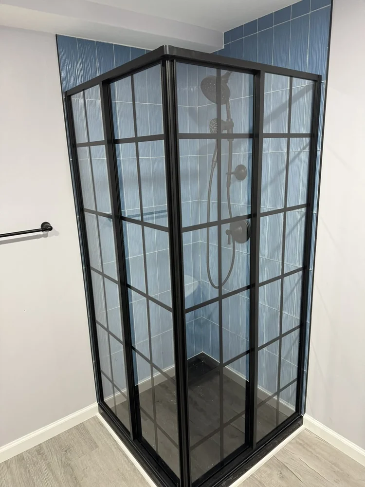 Black grid-glass 40x40 corner shower with blue tile and Kohler shower system – North Wales, PA basement remodel