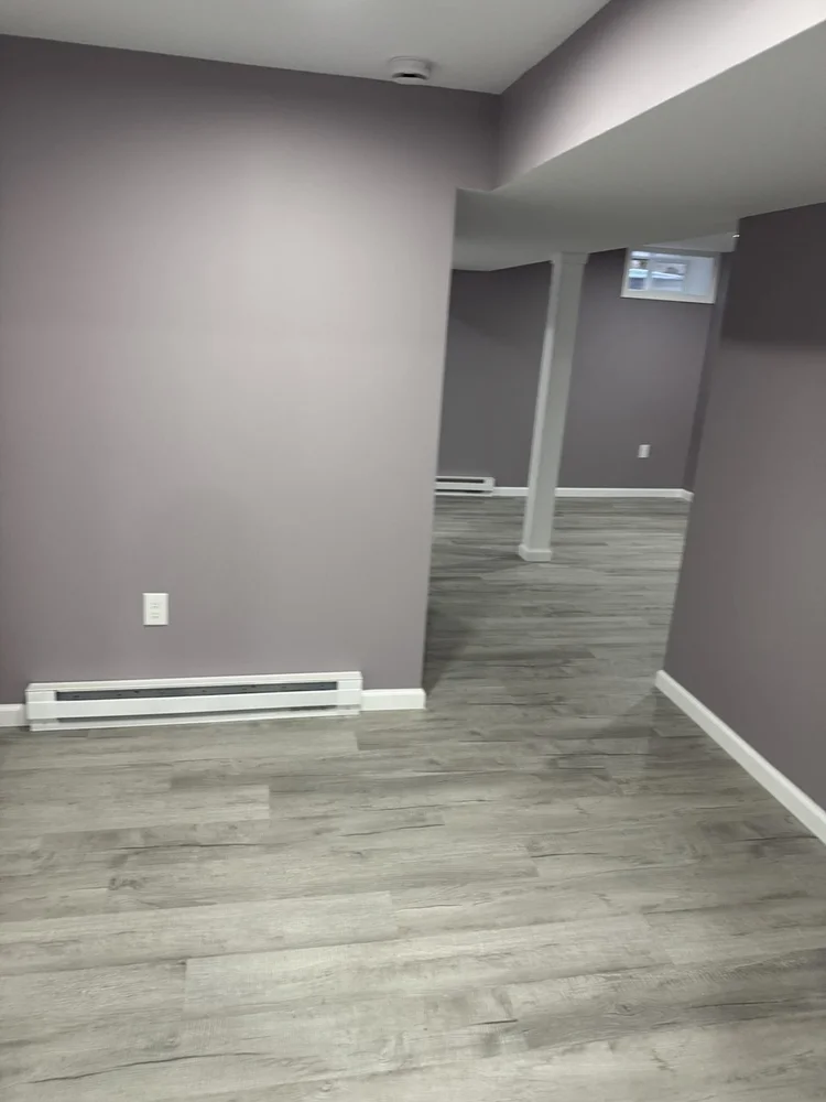 Open living area with baseboard heat – North Wales, PA basement remodel