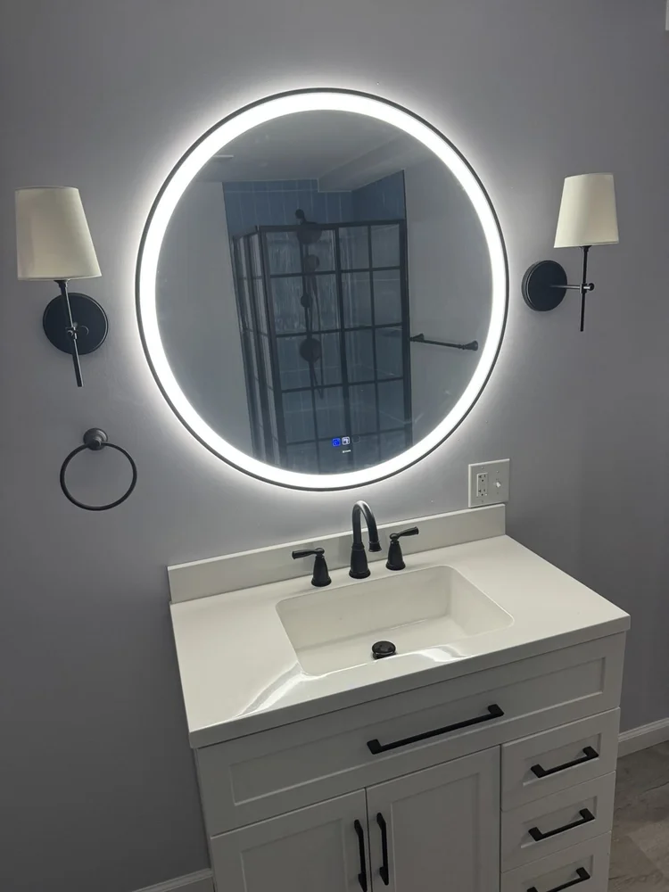 Vanity with LED mirror, wall sconces and black Kohler faucet – North Wales, PA basement remodel