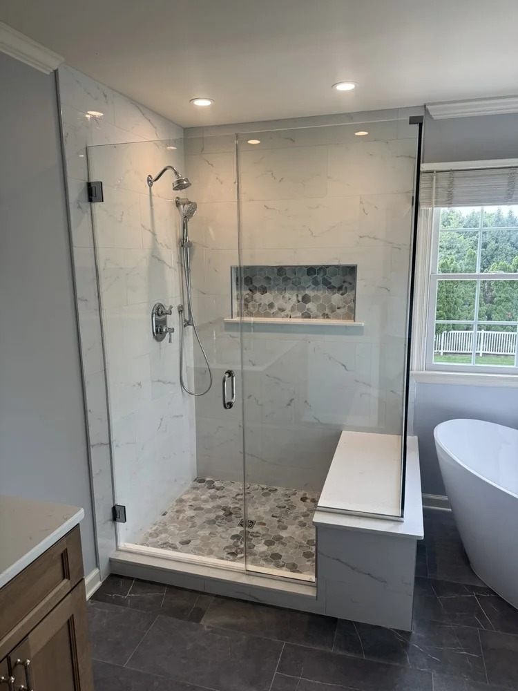 Custom frameless glass shower enclosure with bench and tiled niche – Hatfield, PA primary bathroom remodel