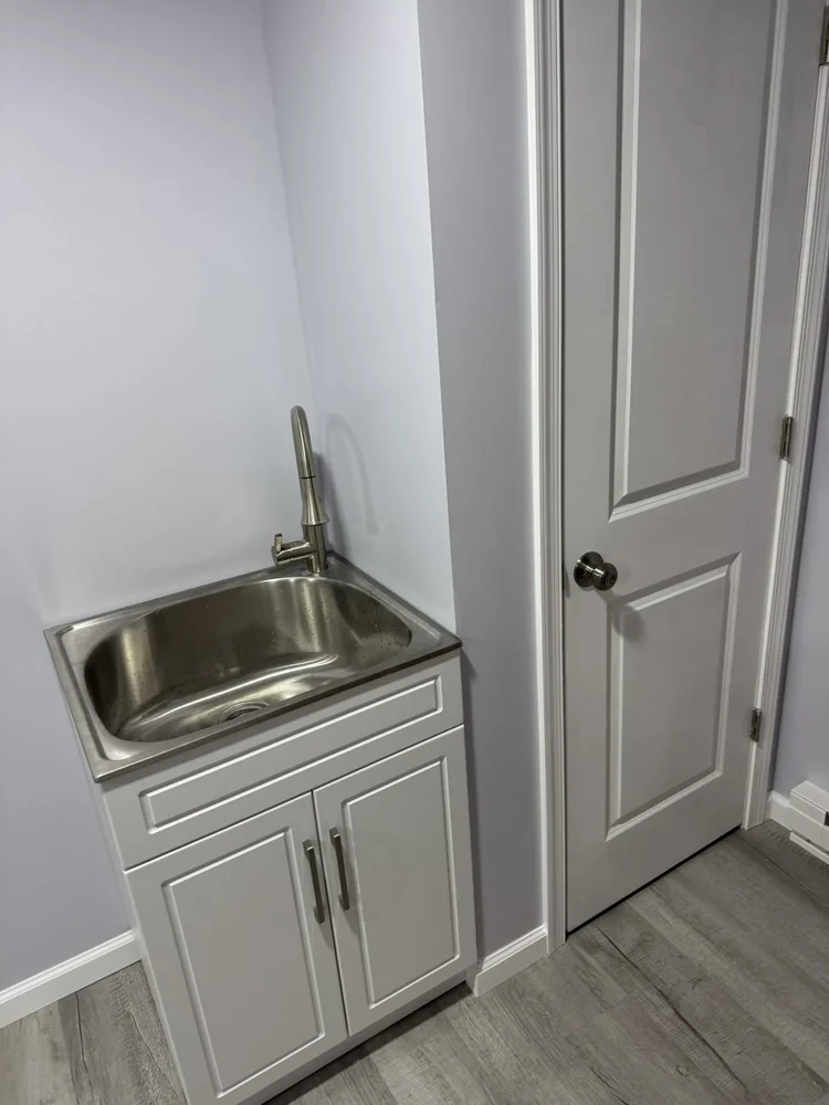 Utility slop sink in a vanity cabinet – North Wales, PA basement remodel