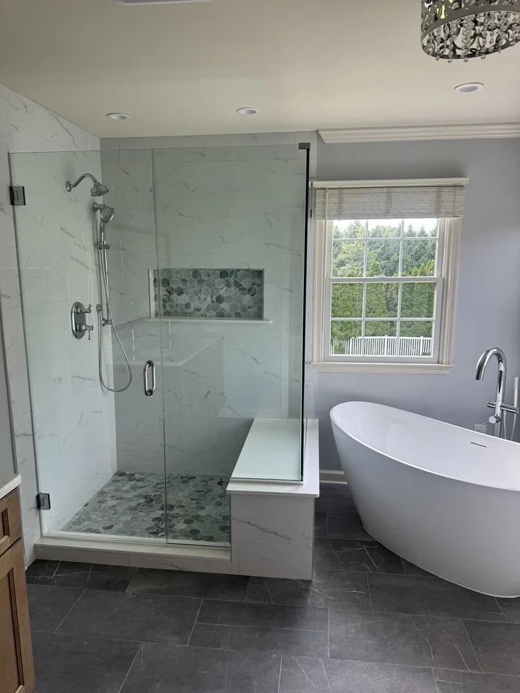 Large glass shower with bench next to the freestanding tub – Hatfield, PA primary bathroom remodel