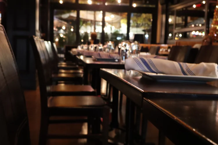 A table set for dinner with the patio lights behind