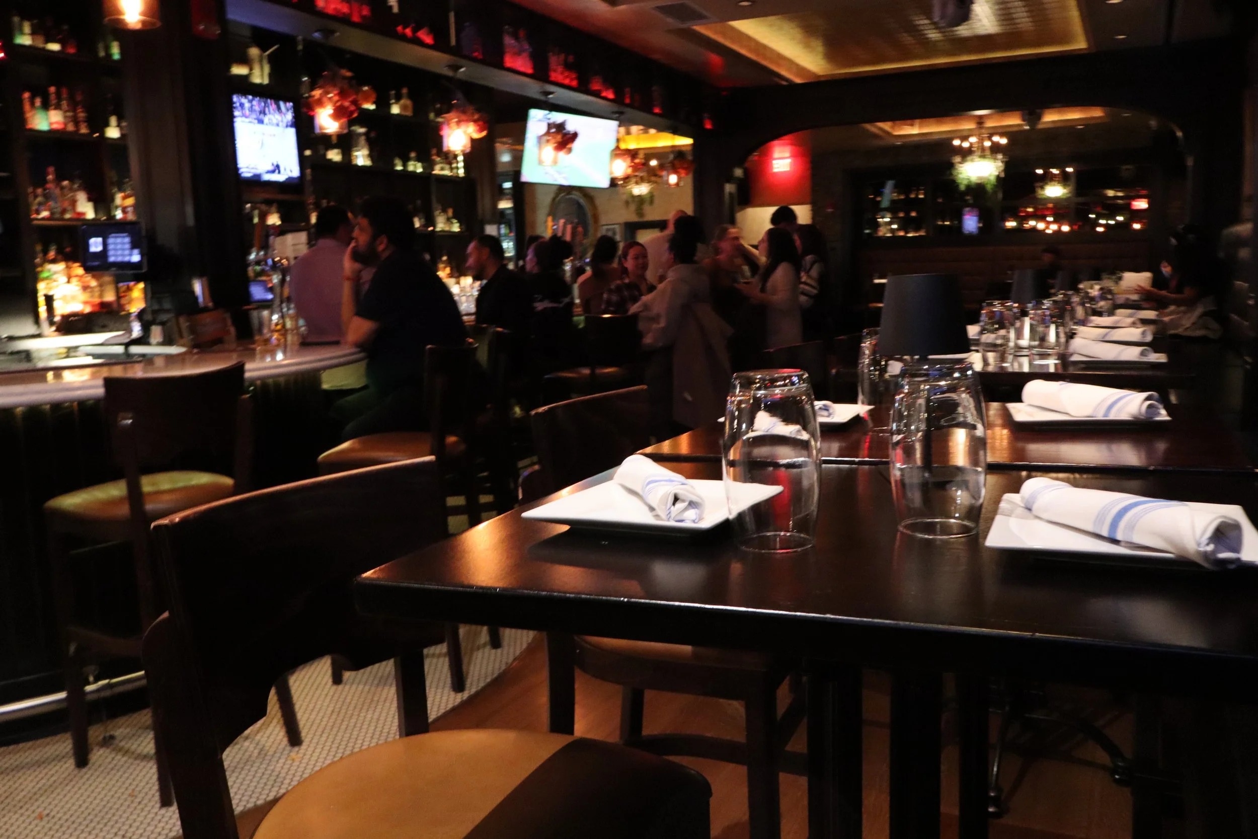 Tables set for dinner beside the Hudson Social bar