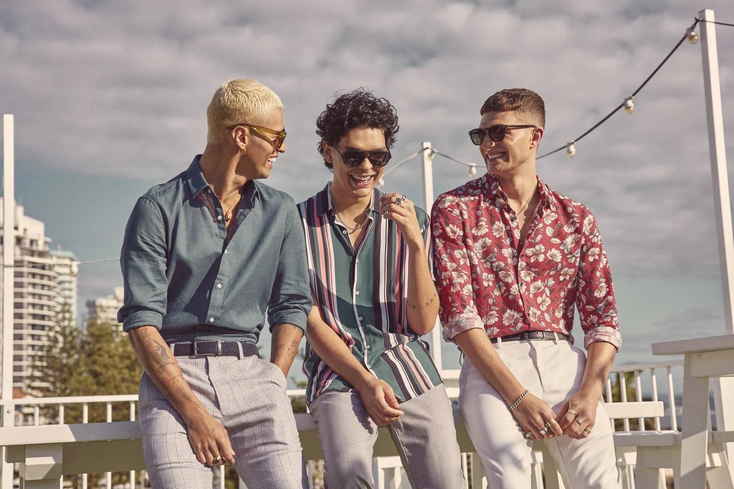 Three models in colourful YD spring menswear on the Pink Hotel rooftop