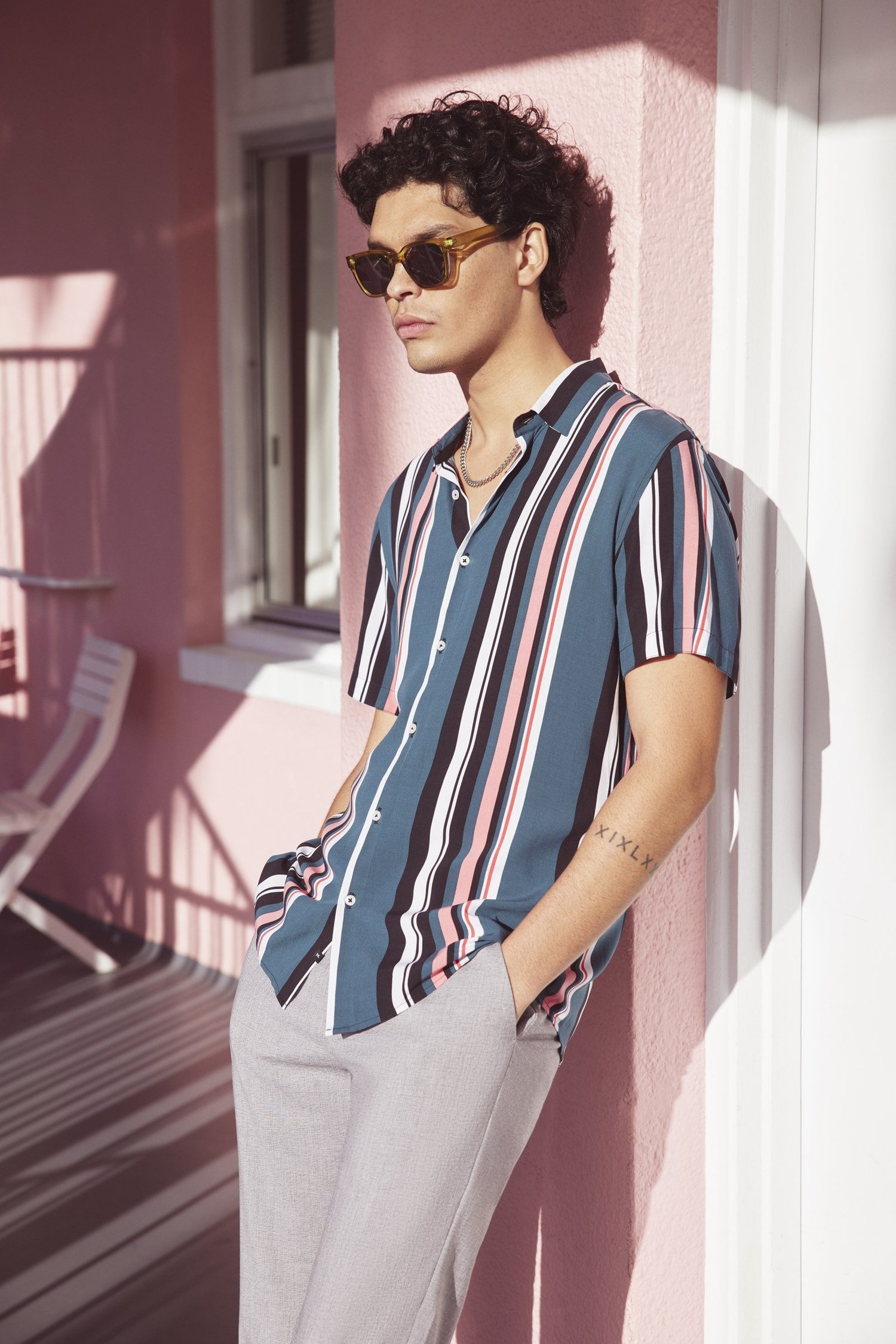 YD Spring Refresh model in a striped shirt outside the Pink Hotel