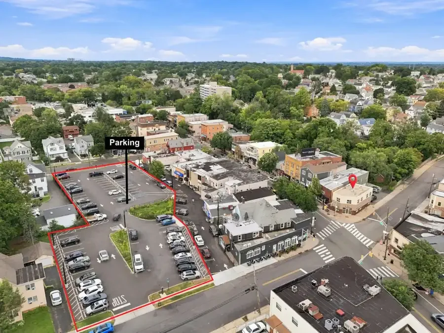 Aerial view of the venue on its corner, with the public parking lot outlined nearby