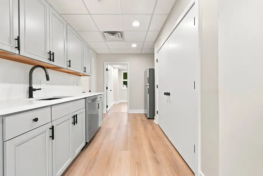 The catering kitchen with quartz counters, dishwasher and refrigerator