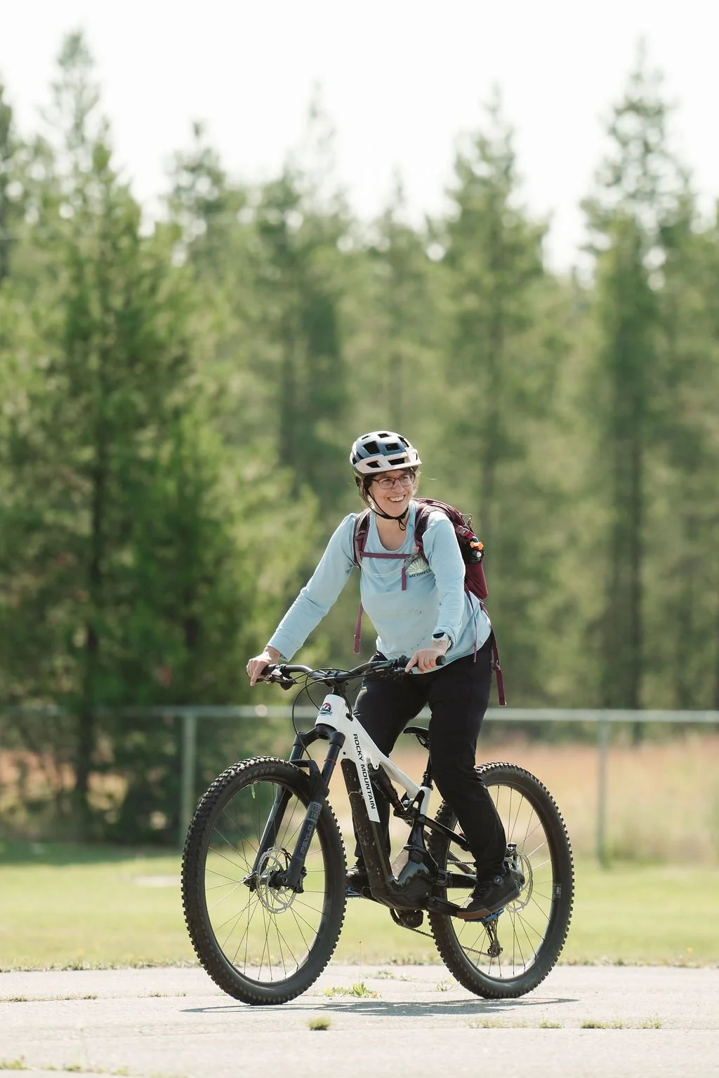 Woman mountain biking with Adventuring Into Life