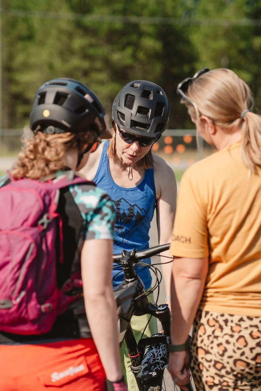 Coach working with a rider on mountain bike skills