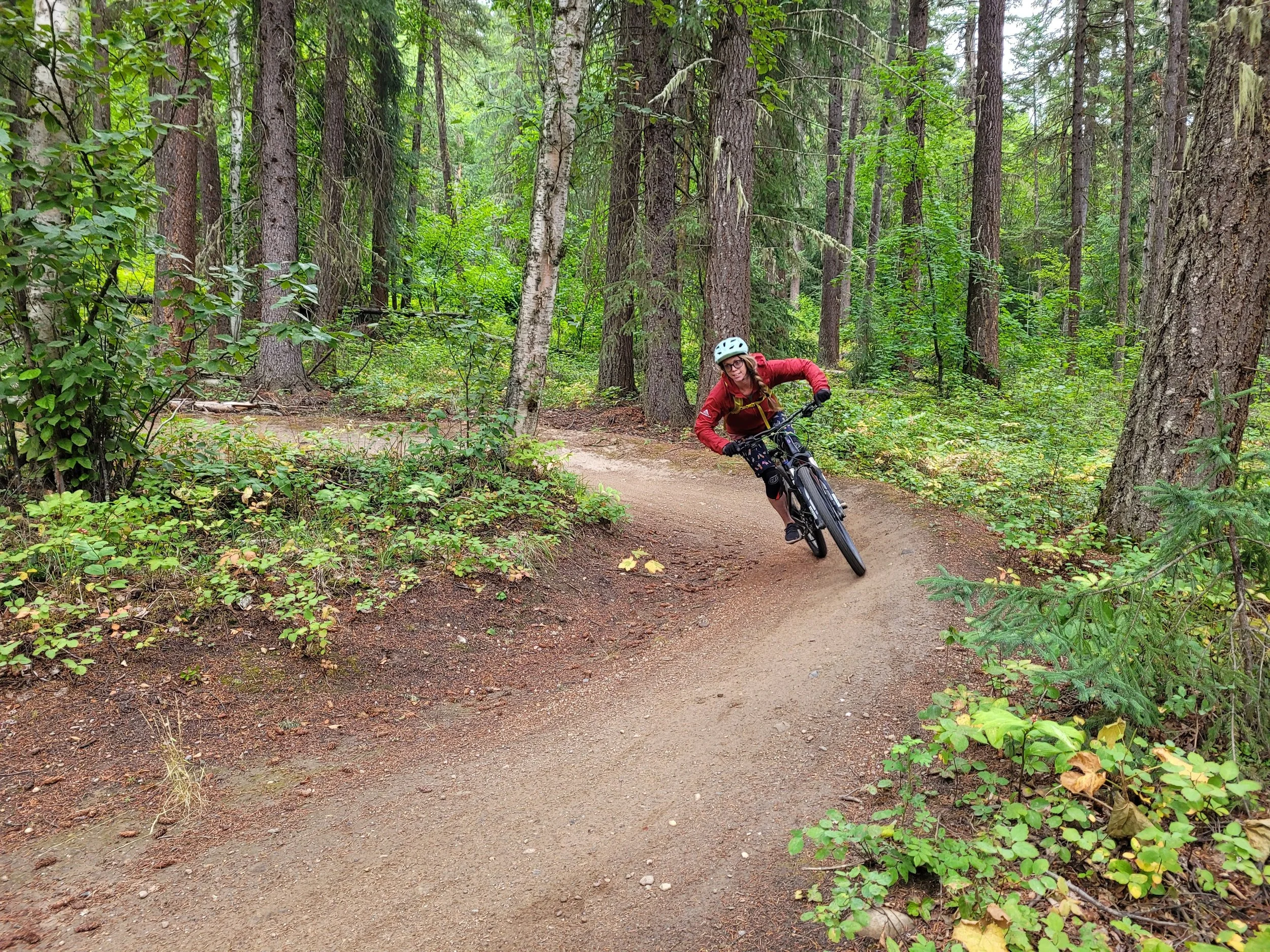 Woman carving corners on Valemount mountain bike trails