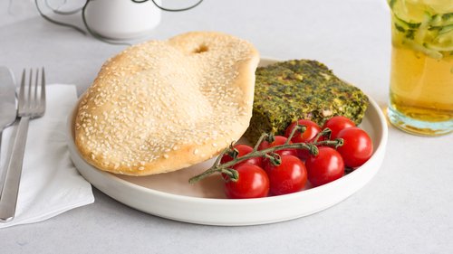 Herb frittata with bread and cherry tomatoes on a plate