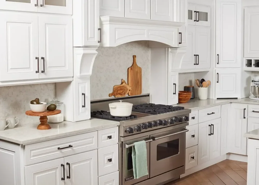 ProCraft Atlas manufacturer kitchen inspiration with white cabinetry, dark hardware and a range hood