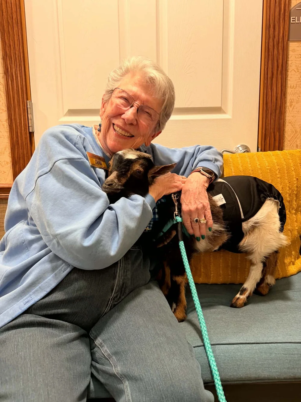 A Hidden Grace Farm goat visiting a senior community