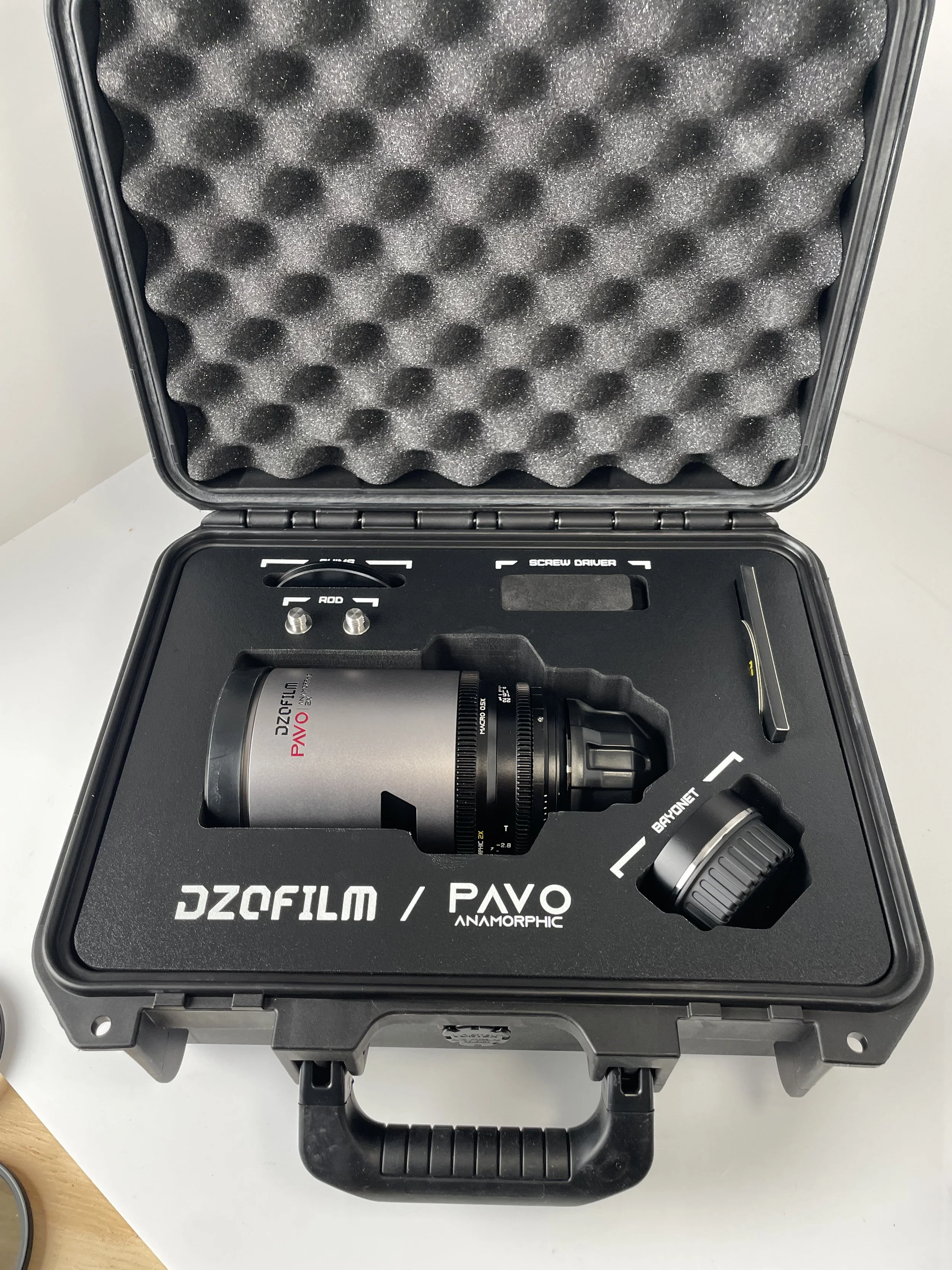 Pavo 65mm T2.8 Macro shown in its case. Confirm included accessories.