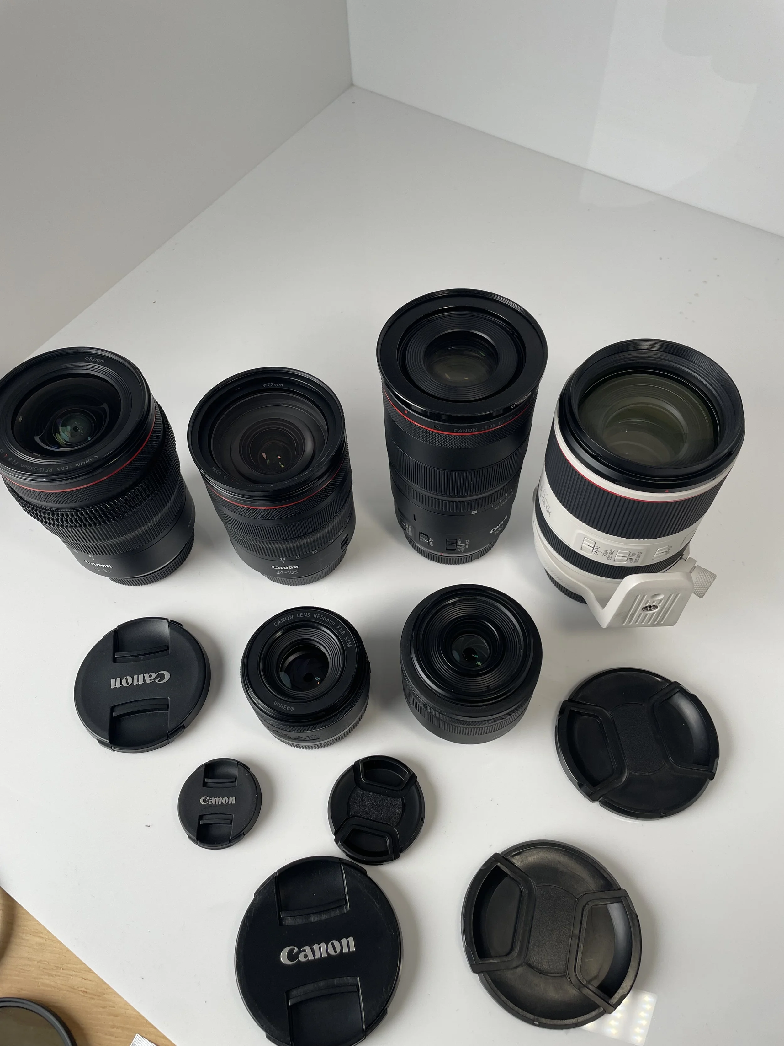 Six Canon RF lenses arranged together. Each lens is priced individually.