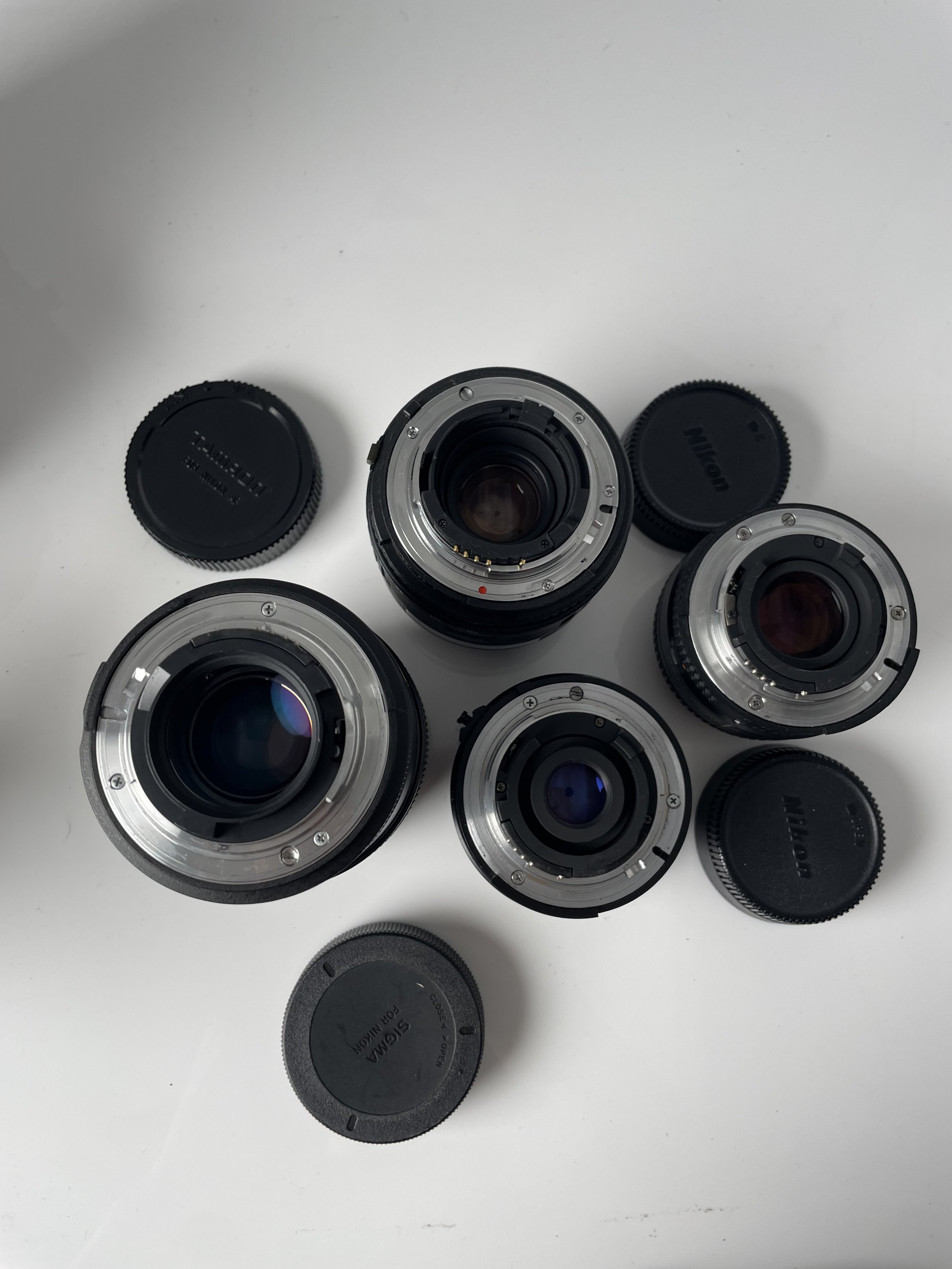 Tamron 90mm and Sigma 28–70mm, plus the Nikkor 28mm and 50mm included only with the N70 and N8008 camera kits. Items are priced separately as listed.