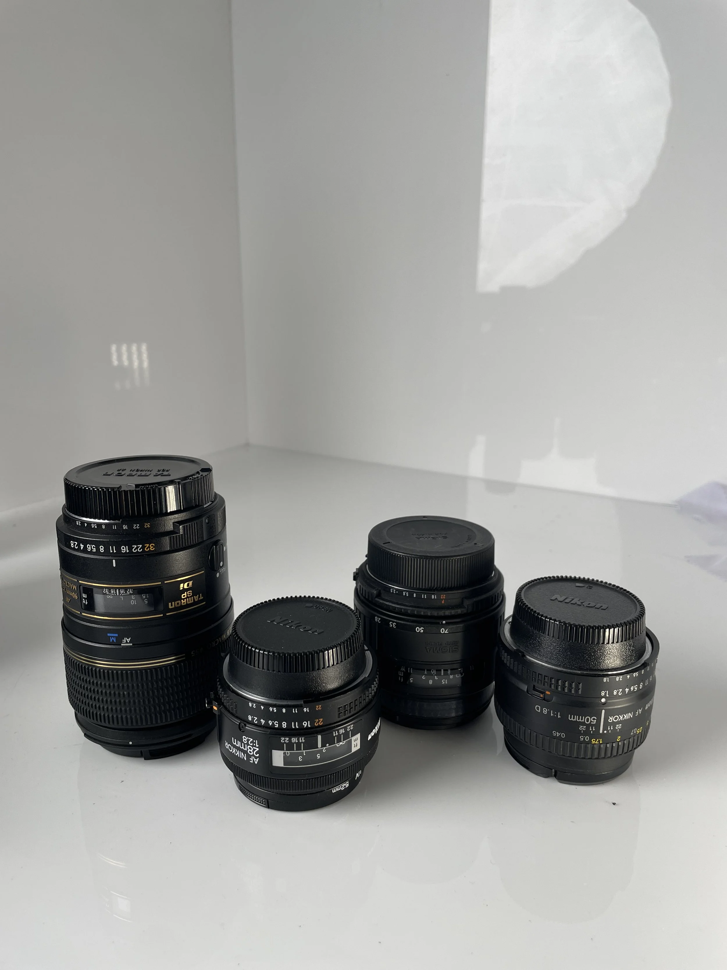 Tamron 90mm and Sigma 28–70mm, plus the Nikkor 28mm and 50mm included only with the N70 and N8008 camera kits. Items are priced separately as listed.