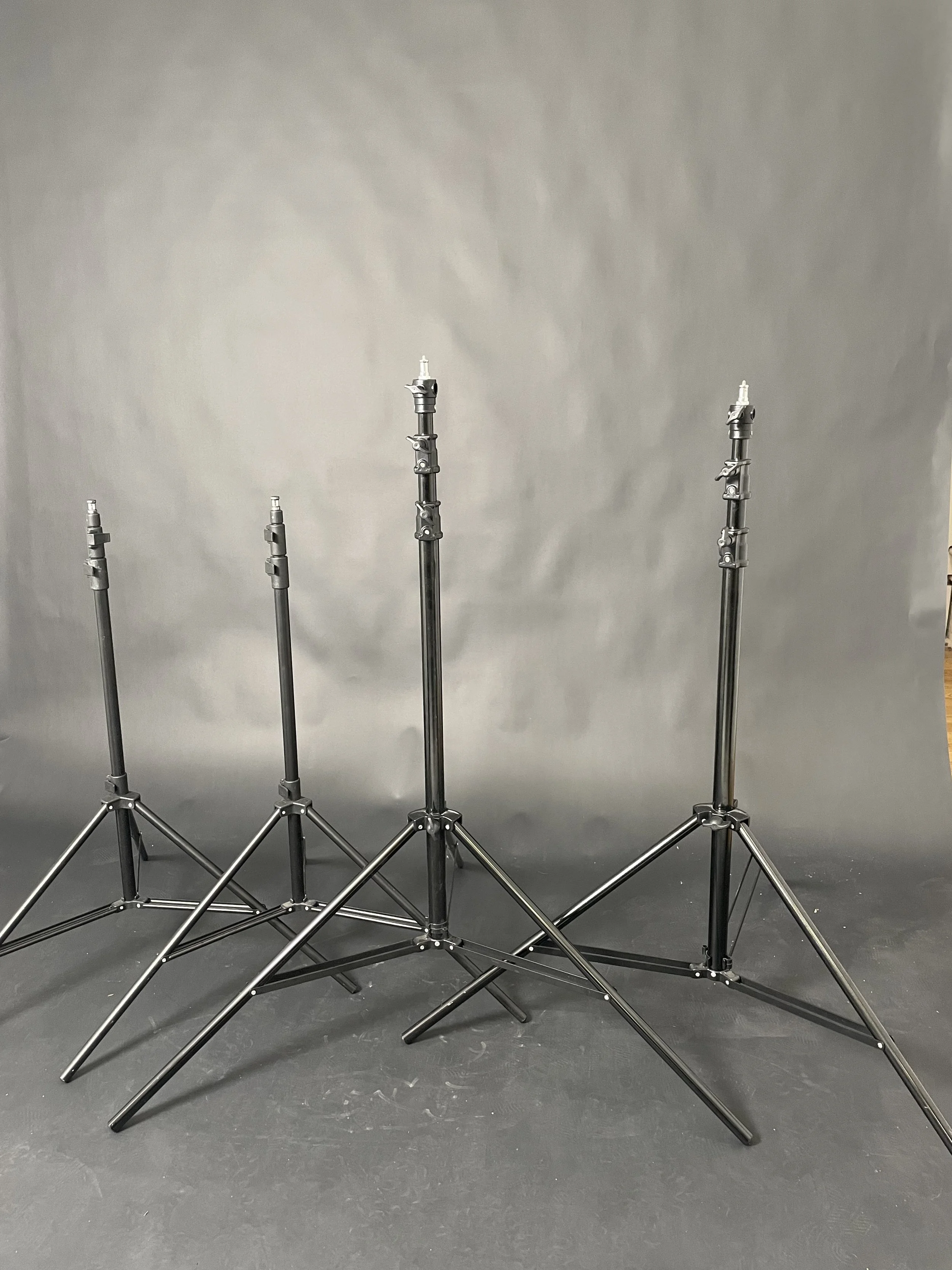 Four black light stands shown. Confirm whether sold individually or together and which are included.