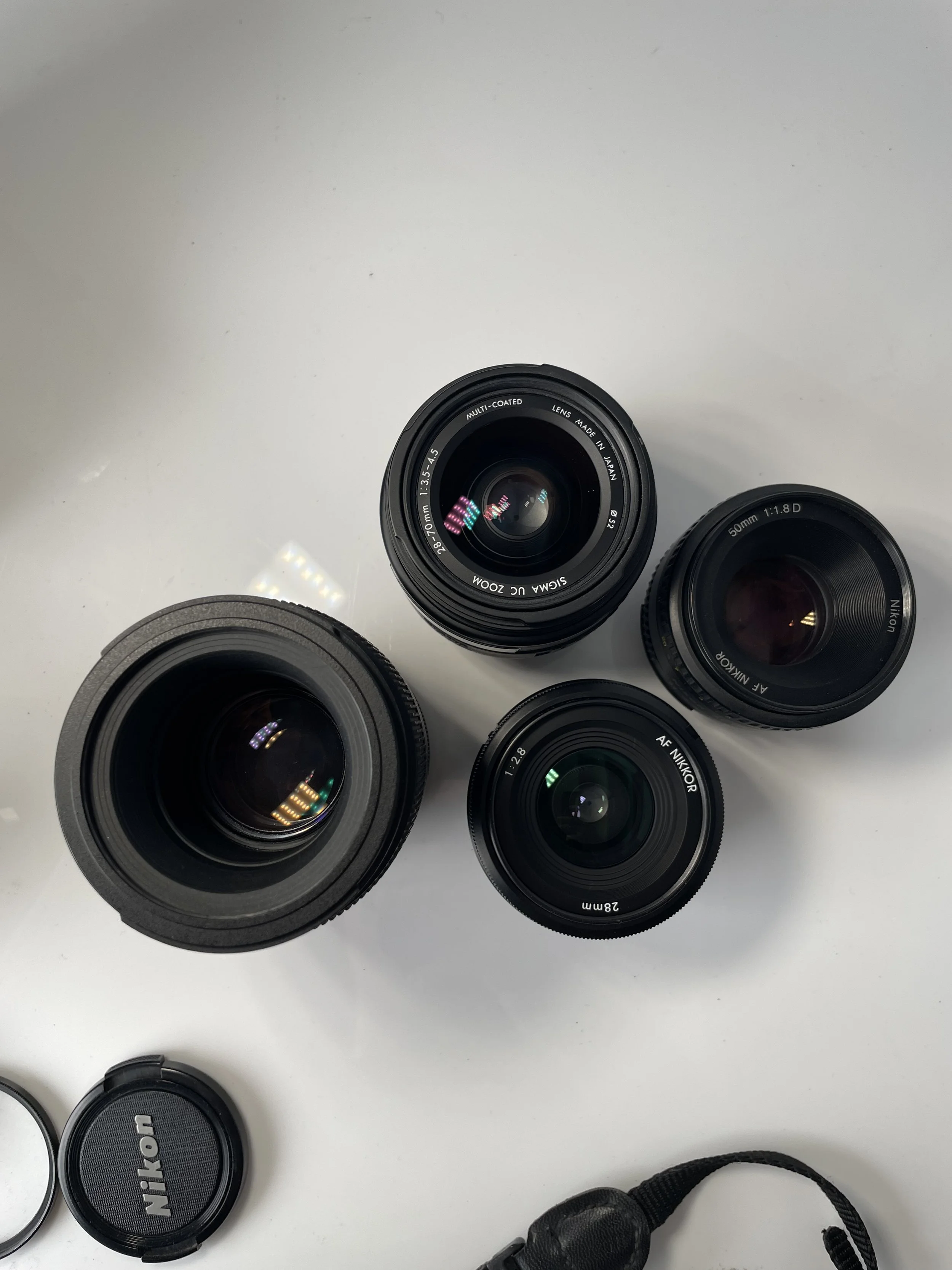 Tamron 90mm and Sigma 28–70mm, plus the Nikkor 28mm and 50mm included only with the N70 and N8008 camera kits. Items are priced separately as listed.