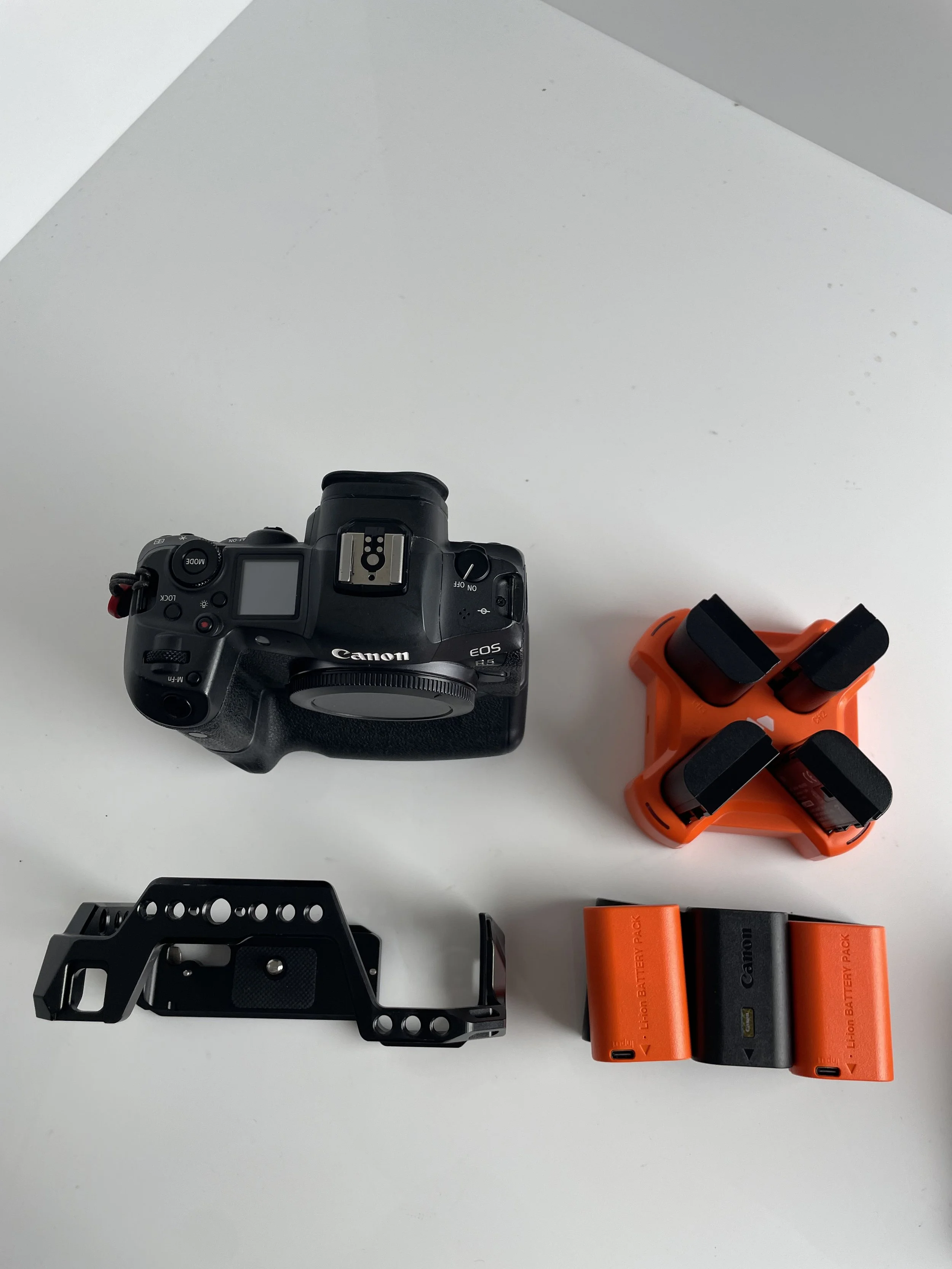 Canon EOS R5 with pictured accessories. Confirm which cage, batteries and charging accessories are included.