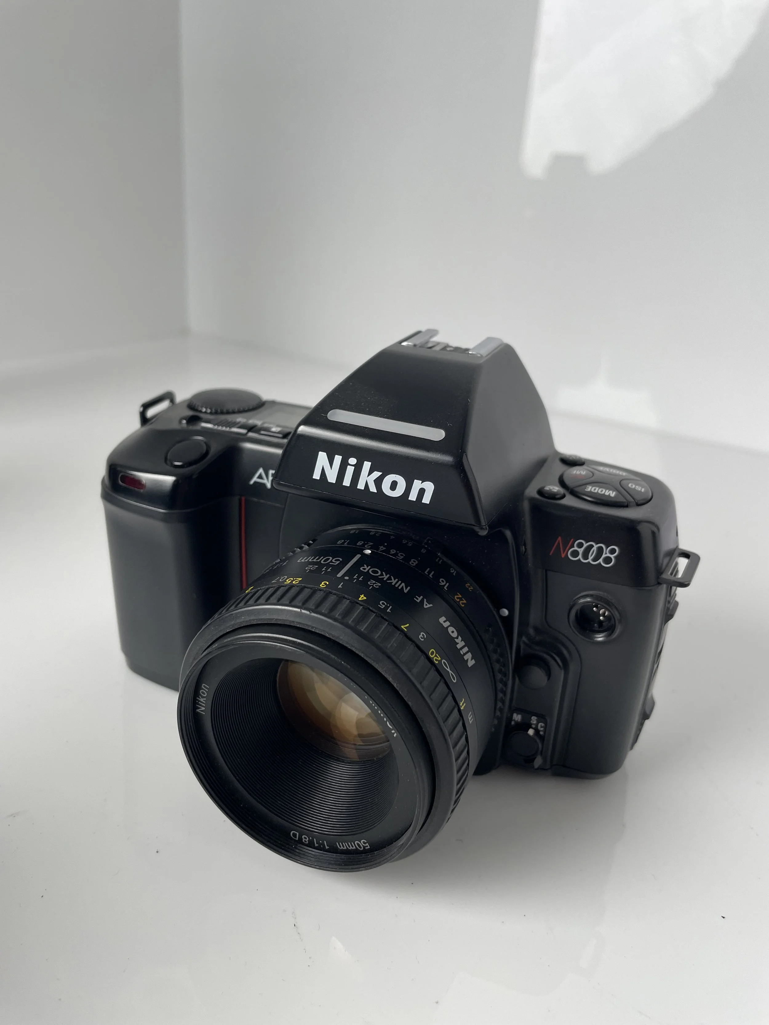 Nikon N8008 with 50mm lens. Body untested; needs batteries.