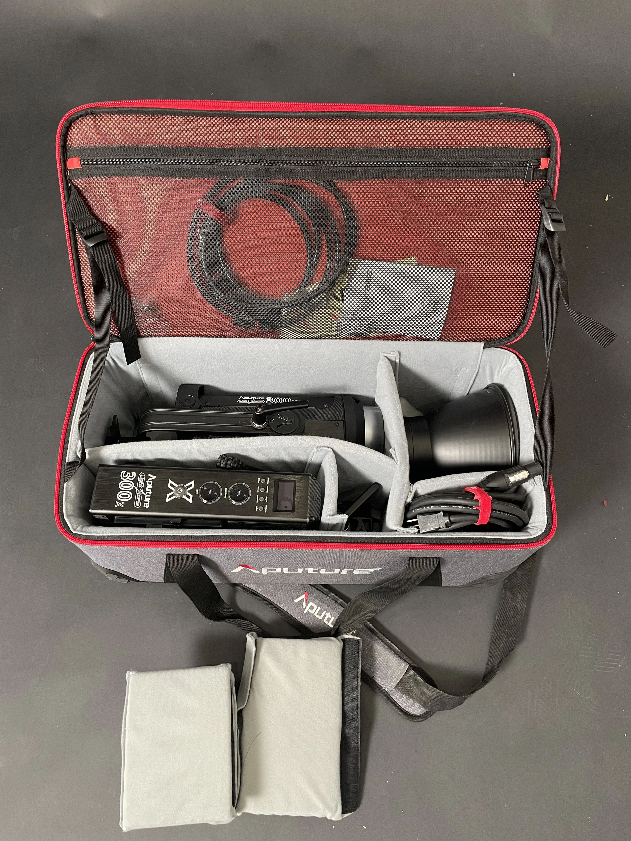 Aputure 300x shown with case and accessories. Confirm the exact included package.