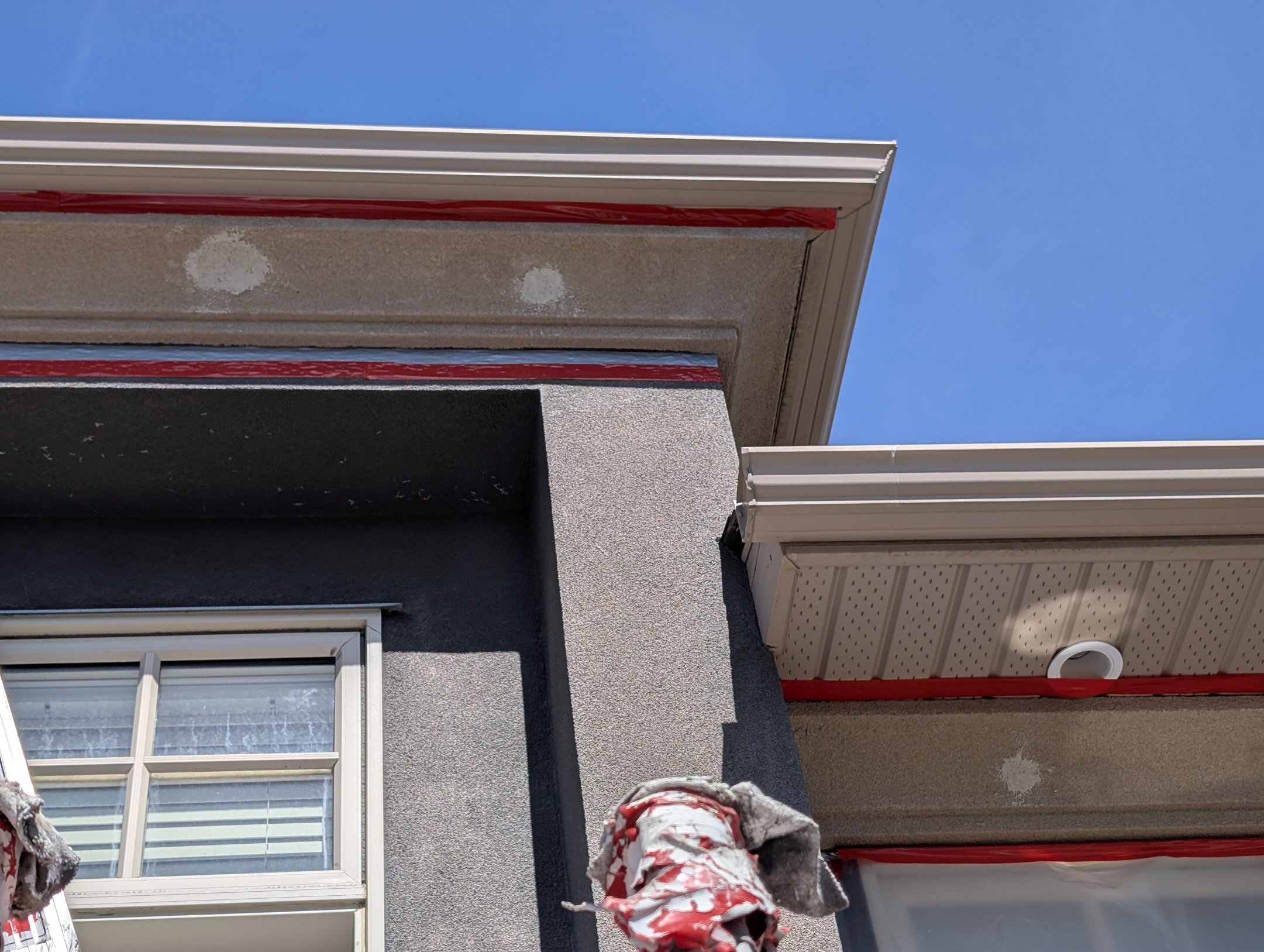 EIFS fiberglass mesh embedded into reinforced base coat for woodpecker protection