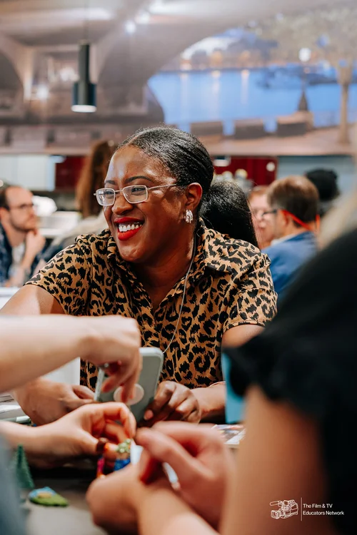Smiling educator taking part in a workshop activity