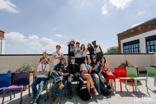 Students posing together on a sunny school rooftop terrace